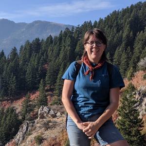 Jes Braun standing in a mountain forest.